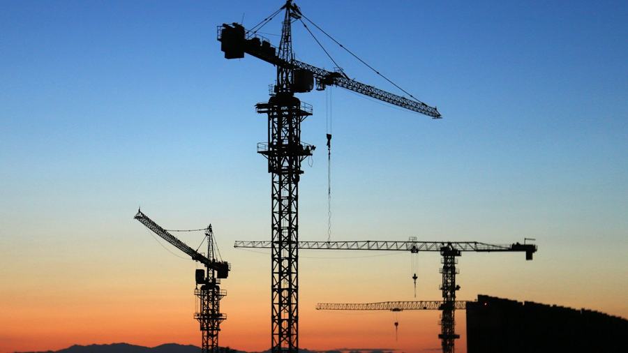 Tower cranes at golden hour